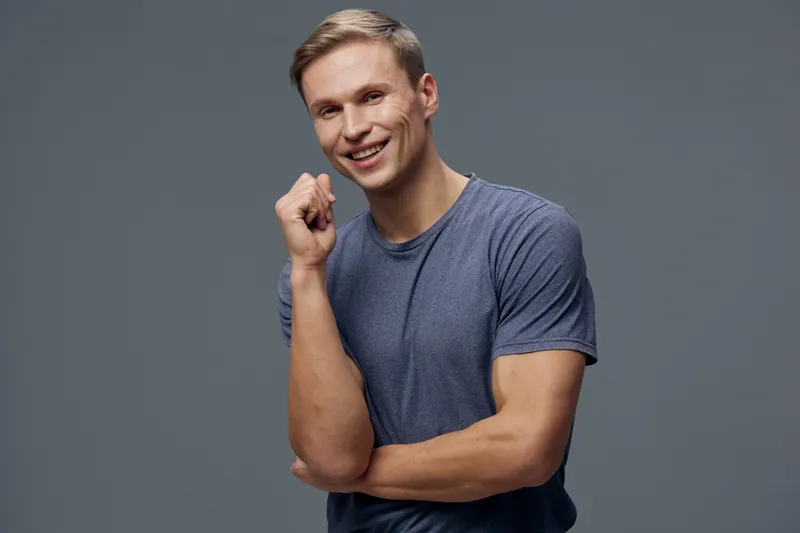 smiling young caucasian man wear blue t-shirt look camera hold fist mental health and gadgets concept digital detox communication concept
