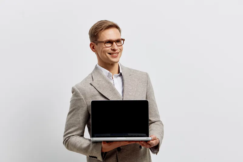 smiling young caucasian man hold laptop wear glasses suit stand isolated on white background digital nomad concept work remote technology business communication