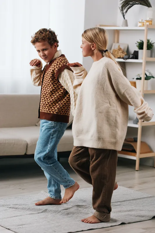Authenticity shines in a cozy home moment, highlighting a playful game theme as a child and caregiver share movement, capturing everyday lifestyle in warm, natural light.