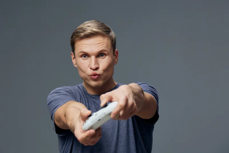 focused man holding gamepad play video game on dark background digital detox concept casual wear entertainment