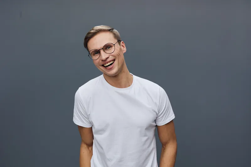 Smiling happy young caucasian man wear glasses white t-shirt isolated on gray background cyber security concept technology protection