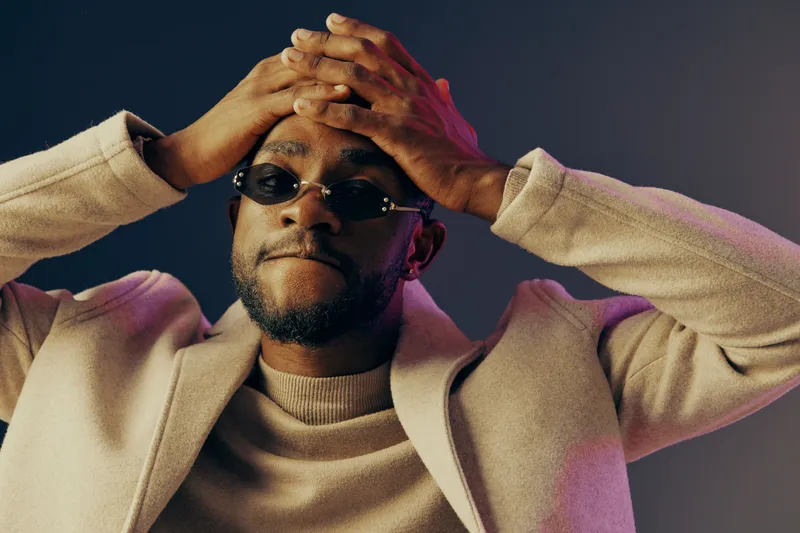 Stylish man in sunglasses expressing frustration against a colorful backdrop, highlighting emotions through fashion and color concepts