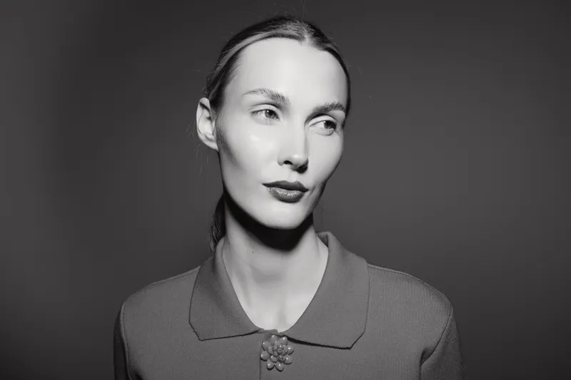 Portrait of a fair skinned Caucasian woman looking sideways in black and white. Soft lighting emphasizes facial features and calm expression.
