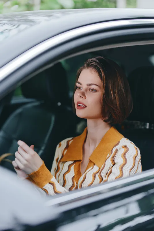 Car, driver, woman, relaxed smile as she sits in the driver's seat with a confident grip on the steering wheel, radiating calm readiness for a journey and new adventures.
