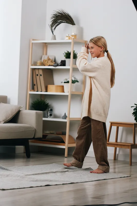 Authentic scene of a child at home engaged in a playful activity, reflecting a school themed moment and everyday lifestyle in a cozy setting.