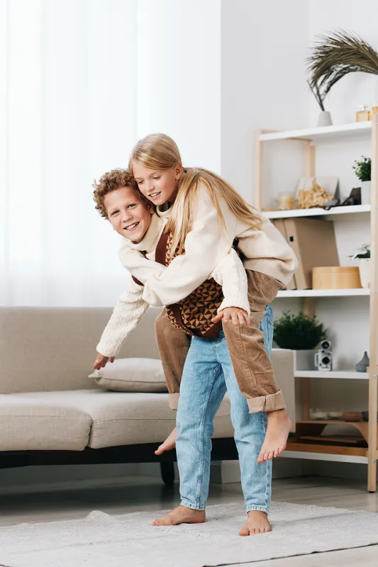 Authentic lifestyle scene of playful interaction at home, featuring a school themed moment of care, imagination, and shared joy between family members.