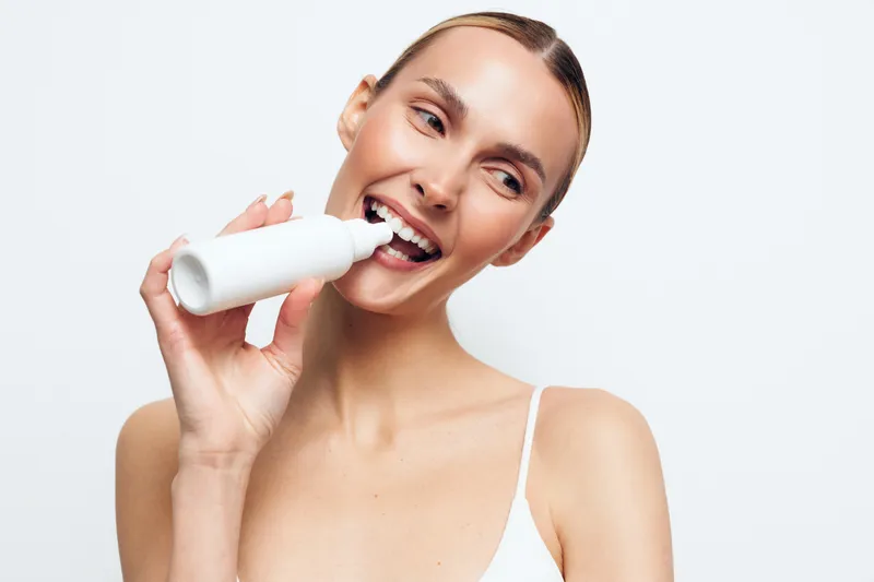 Woman, milk, drinking, bottle, beauty, wellness, nutrition, hydration, skin, care, smiling woman drinks milk from a white bottle, studio close up, healthy hydration