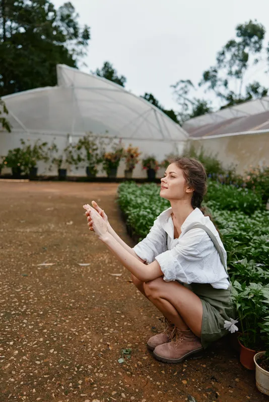 Young woman in nature, wearing casual outfit, enjoying tranquility in a garden Focus on sustainable living and healthy lifestyle