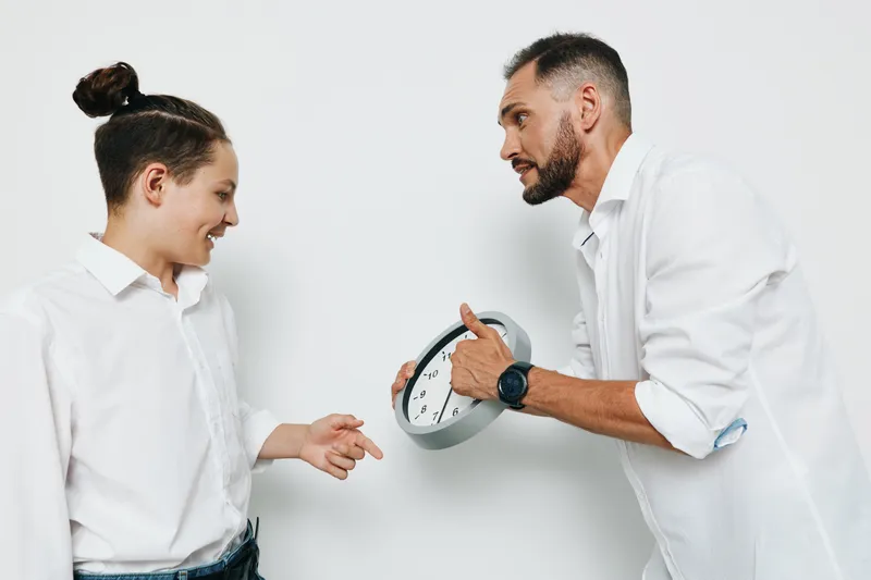 A professional man and colleague share a moment on an isolated color background, showing confident emotion and strong business focus.