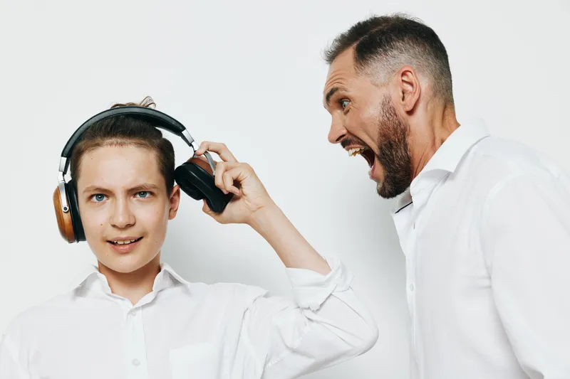 A business professional stands beside a young colleague, projecting confidence and emotion, against an isolated colored background that highlights focus, energy, and serious intent.