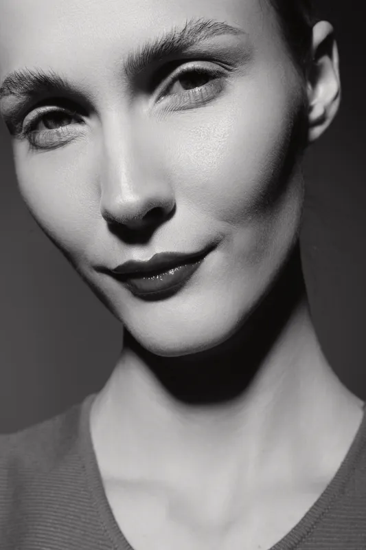 Close-up of a pale white woman with smooth skin and short hair in black and white. Concept of natural beauty, facial expression, and monochrome portrait photography.