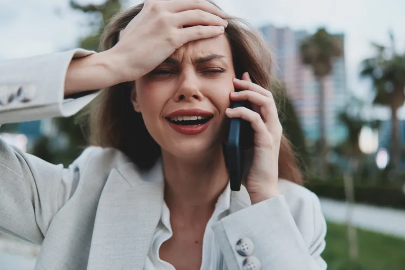 Expression of Anxiety: Young Businesswoman on the Phone in Urban Setting