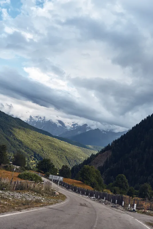 mountain road valley clouds landscape nature sky winding path through mountains with moody overcast weather
