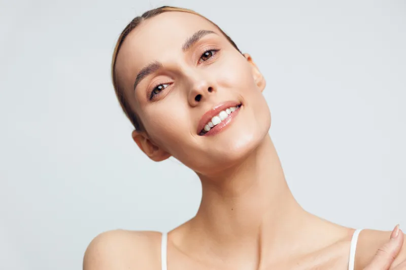 Smiling woman, portrait, close up, beauty, skincare, natural skin, healthy complexion, isolated on white background, studio lighting, young adult, copy space, calm expression