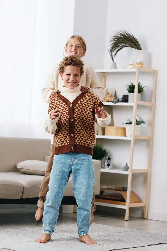 Authentic playful scene featuring youths in cozy wardrobe, showcasing a school lifestyle moment during a friendly game, candid and natural expression.