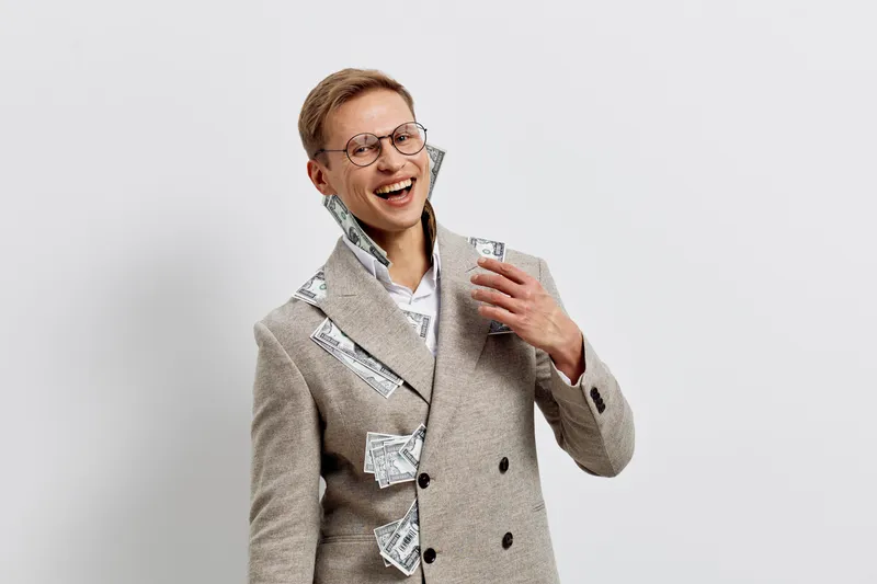 smiling man with money smart casual double-breasted coat joyful pose white background concept freelance finance success