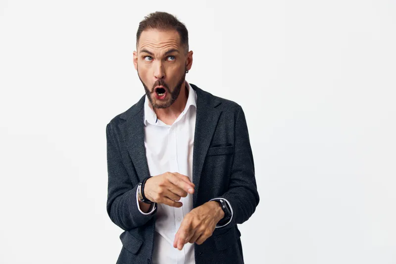 A professional man in business attire on an isolated colored background, expressing surprise and shock, capturing dynamic emotion perfect for corporate campaigns and marketing material.
