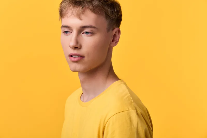 Yellow, man, studio, fashion, model, casual look with relaxed expression against a monochrome yellow backdrop, clean lighting and minimal wardrobe for a versatile stock visual