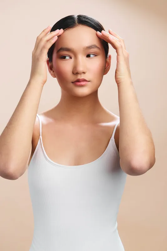asian woman portrait in a studio, calm expression and soft lighting create an elegant, poised mood suitable for beauty and fashion campaigns and editorial use
