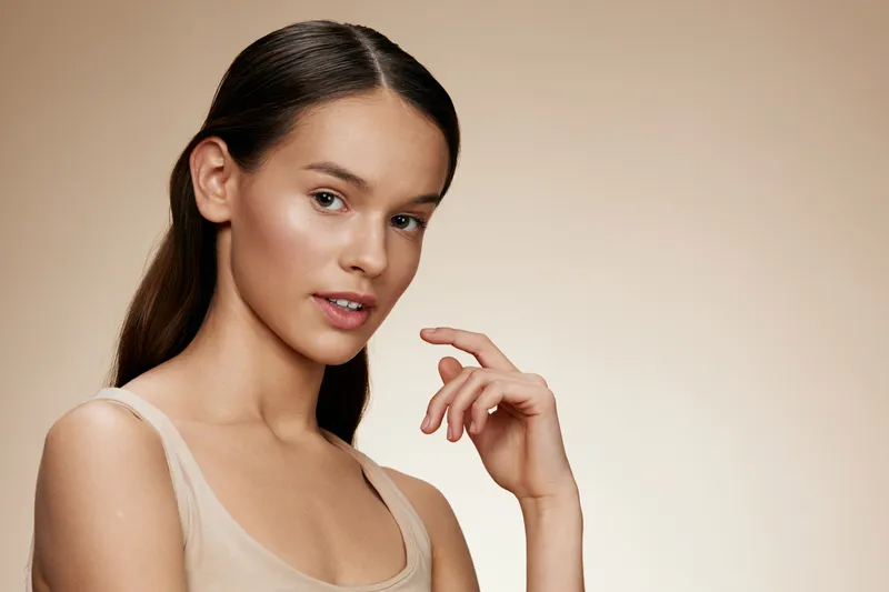 Portrait of a young woman with natural makeup showcasing healthy skin and a soft expression, perfect for beauty and skincare themes