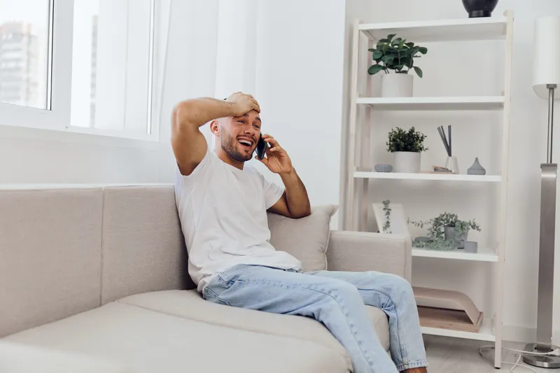A stressed man on the phone, showcasing emotions related to AI anxiety and work-life blur, reflecting the challenges of modern living.
