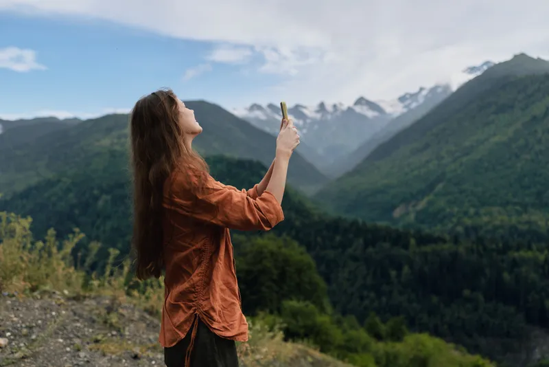 woman mountains nature hiking phone landscape outdoor authenticity inclusivity
