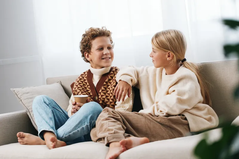Authentic scene of children at home enjoying a playful moment, showcasing a school influenced lifestyle, curiosity, friendship, and gentle learning in a cozy setting.