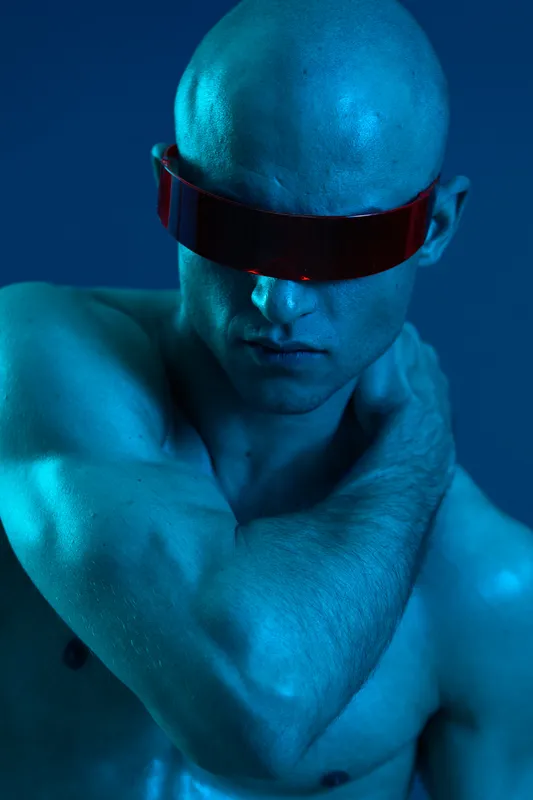 A striking image of a man with a futuristic visor in a blue tone, showcasing abstract elements and strong emotions. This stunning visual captures an innovative aesthetic.