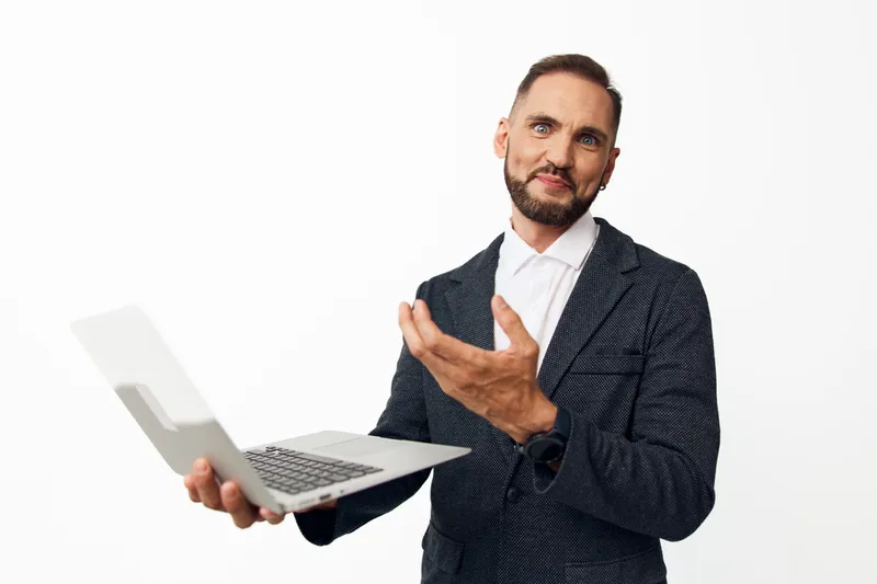 Professional businessman on an isolated colored background, presenting with a laptop, conveying confidence, competence, and approachable mood for corporate, tech, and leadership topics.