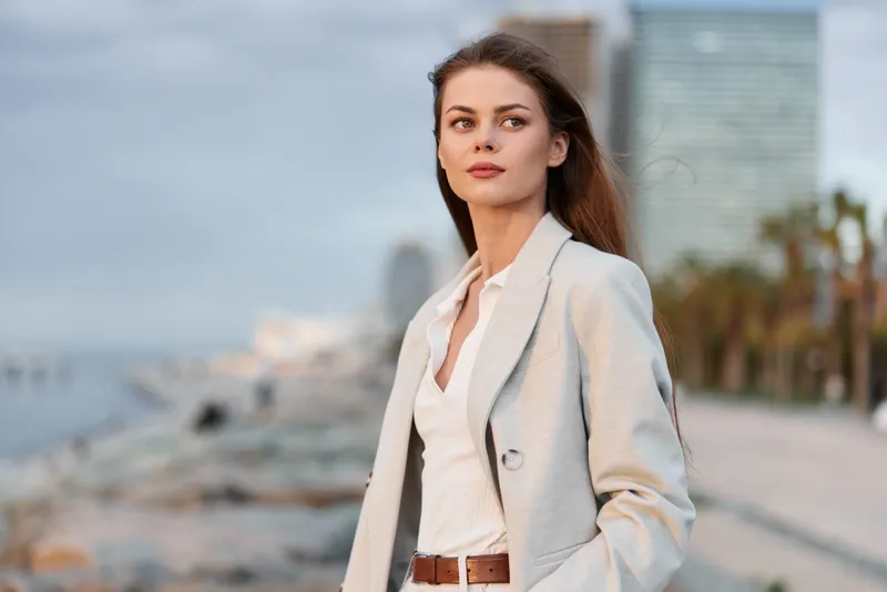 confident woman in beige blazer outdoors urban background business professional portrait natural light
