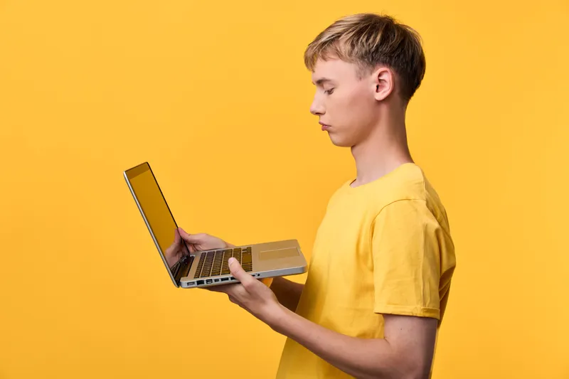 Laptop, yellow, young, male, holding, device for learning, education, technology, concentration, online study, casual workspace, modern environment, youth education