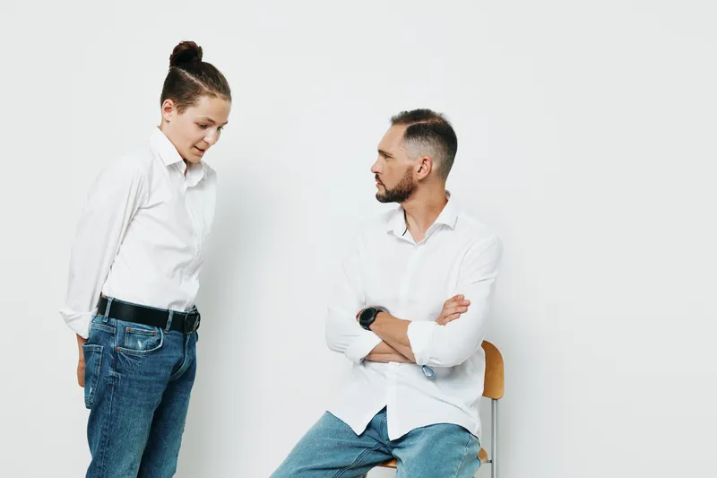 A professional man and woman on an isolated white background, showcasing business mood, calm confidence, and thoughtful concern during a focused discussion about strategy and goals.