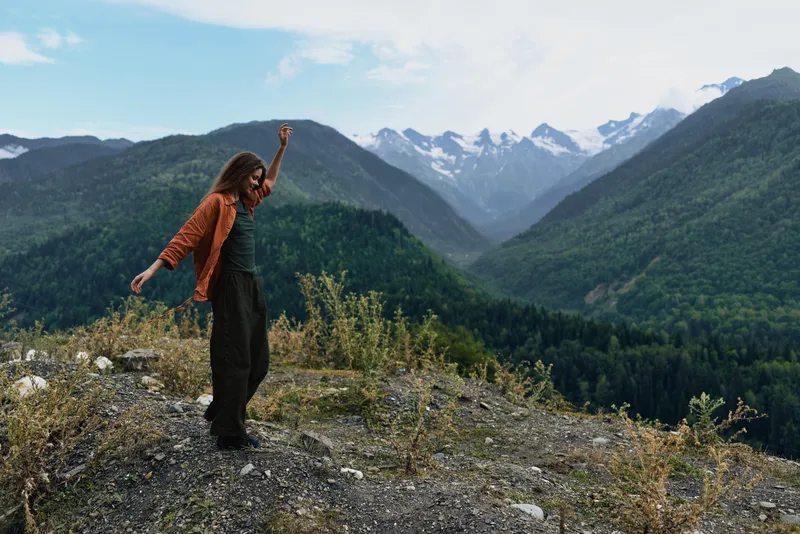 Person hiking in mountains and nature, woman on ridge landscape view, authenticity inclusivity