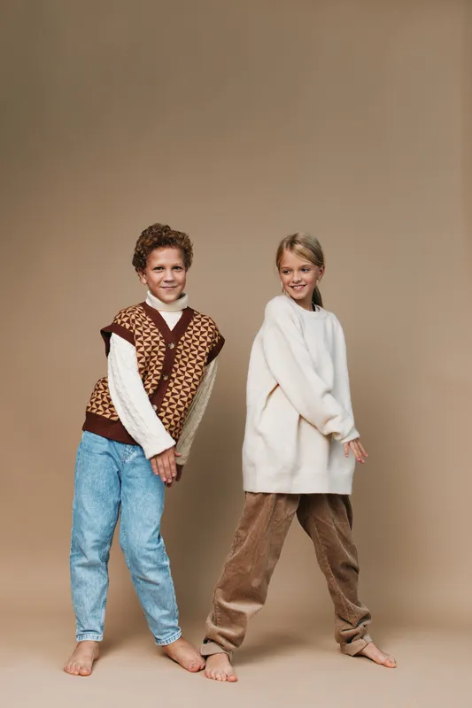 Authentic scene of two children at play in cozy, everyday outfits, capturing a school inspired wardrobe and genuine mood that highlights lifestyle and candid charm.