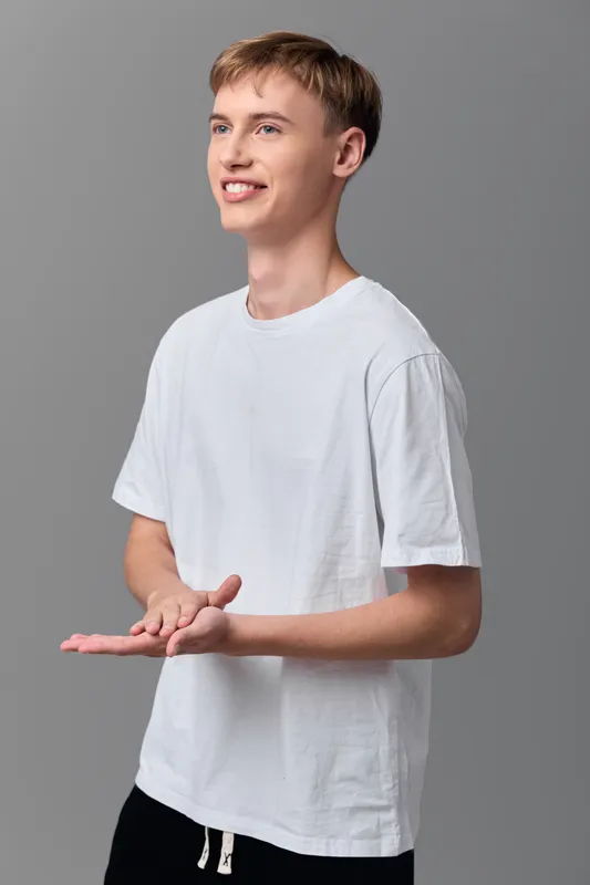 Hands presenting man white shirt casual gesture smile body language demonstration presenter showcasing friendly approachable stance for lifestyle marketing retail concepts and product demonstration