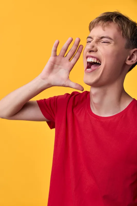 Shouting boy, loud voice, red shirt, hand gesture, energetic pose, vibrant background, expressive face, youth energy, dynamic action, casual style, attention grabbing, motion and emotion