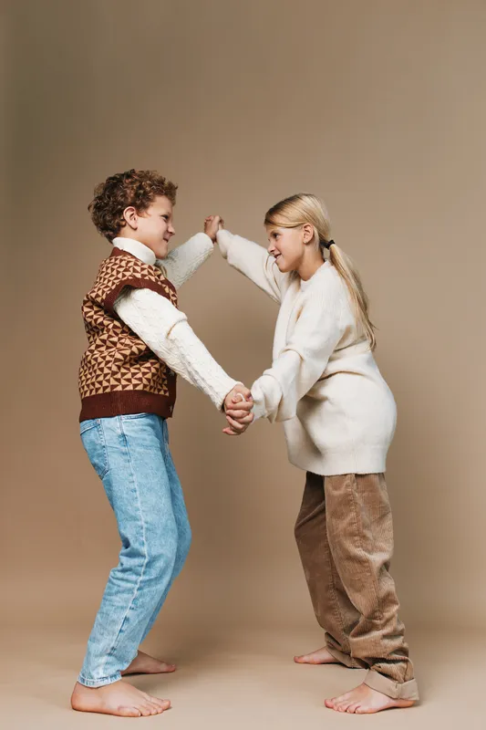 Authentic scene of children engaging in a playful game, capturing school life and everyday lifestyle with warm tones, candid expressions, and gentle teamwork.