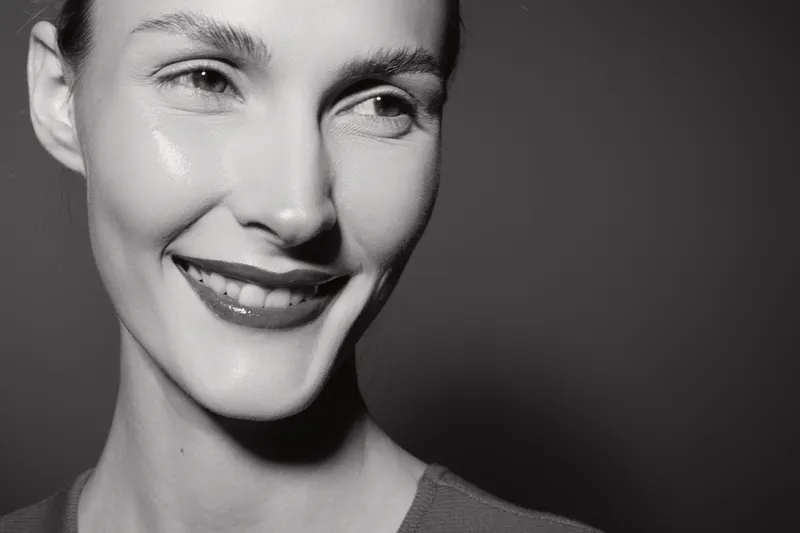 Close up portrait of a smiling white woman with light skin and short hair in black and white. Concept for happiness, beauty, and positive emotions.