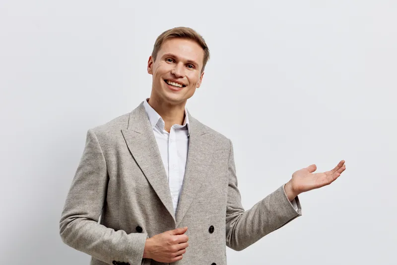 Smiling man wearing plaid blazer show gesture hold invisible object isolated white background studio portrait business casual digital nomad concept