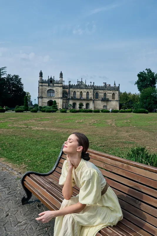 Woman bench historic building castle park dress relaxation authentic inclusive