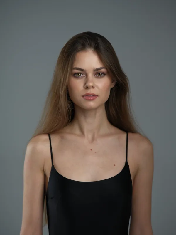 Portrait of a young woman with long brown hair wearing a black dress, neutral expression, studio background, elegant and minimalistic style.