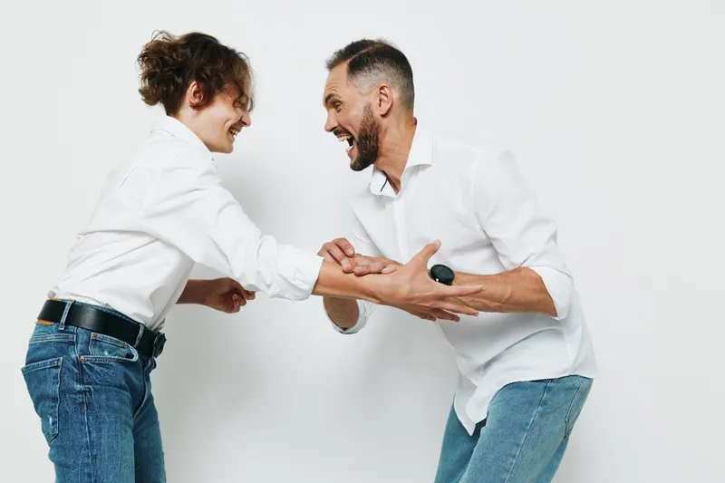 A professional man and colleague share a confident moment against an isolated colored background, conveying business focus, positive energy, teamwork, and leadership in a modern context.