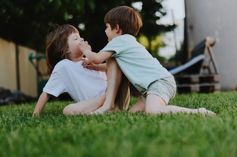 Happy kids playing outdoors in the garden, enjoying a sunny day with laughter and joy. Perfectly captures the essence of childhood fun and connection.