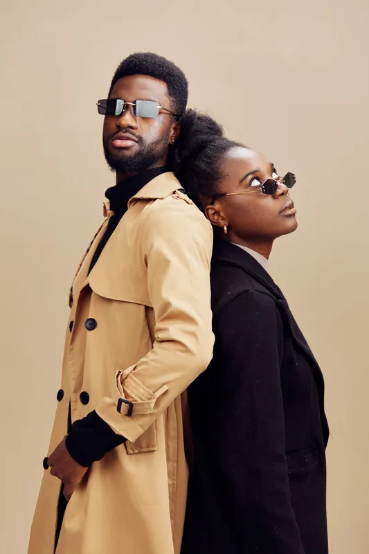 Stylish African models in trendy sunglasses showcase modern fashion, confidence, and elegance against a neutral beige background