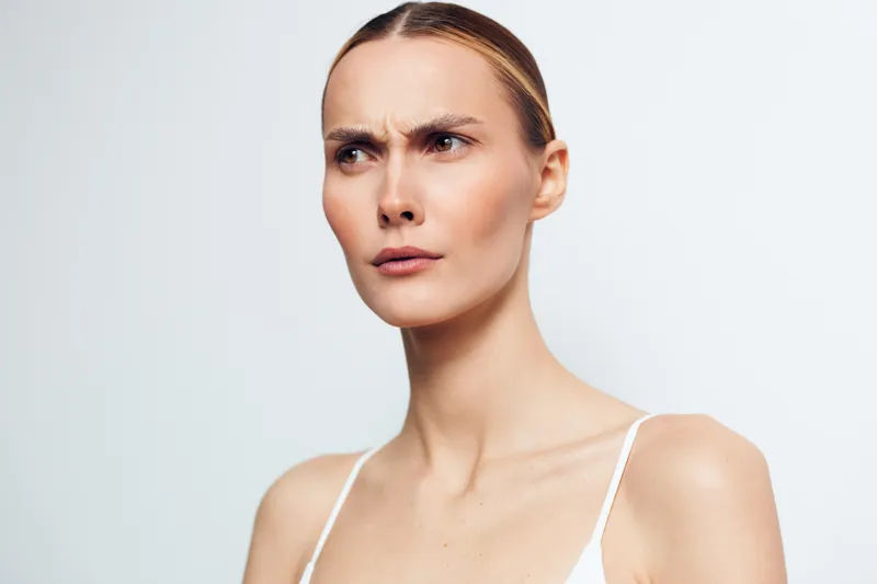 Woman portrait skincare beauty face spa wellbeing smooth skin closeup, gentle moisturiser routine, calm expression, soft studio light on clean background, wellness and self care concept