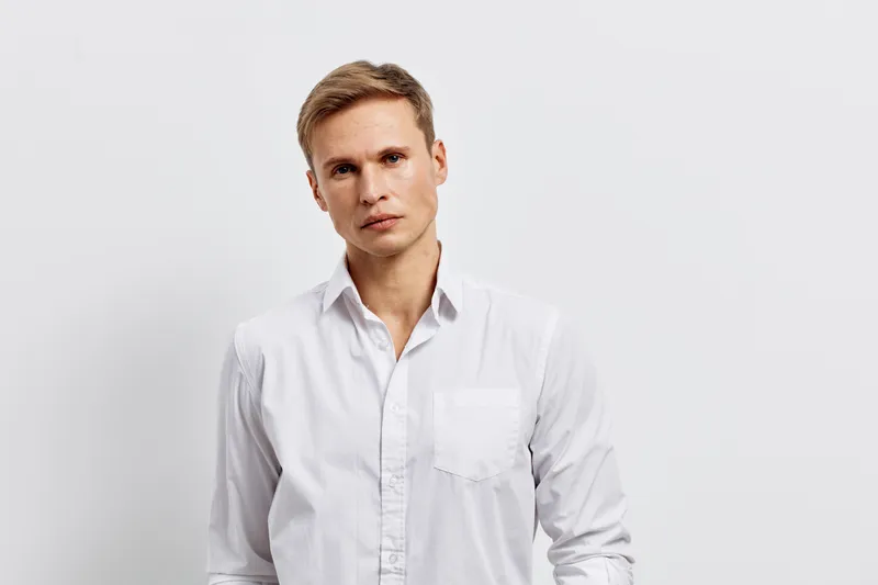 serious young caucasian man wear white shirt look camera isolated on white background portrait digital detox concept mental health gadget