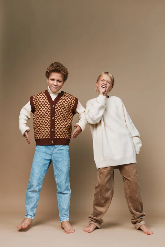 Authentic image featuring children at play, capturing a school lifestyle moment with casual style, warm tones, and natural interaction that conveys real youth energy.