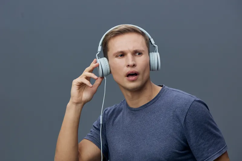 young caucasian man with headphones listening focused on music enjoying sound technology concept digital detox mental health