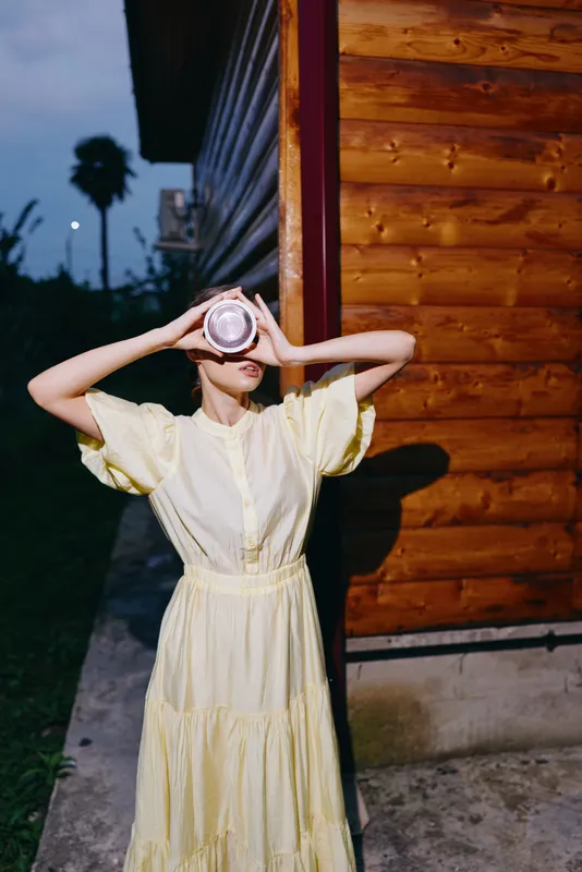 Woman dress holds cup wooden wall authenticity inclusivity