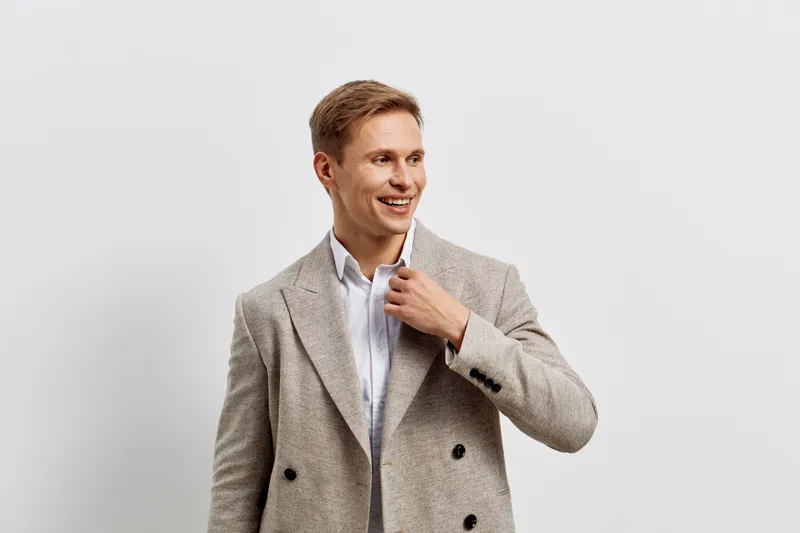 smiling man wearing beige jacket white shirt look side isolated on white background digital nomad remote work concept
